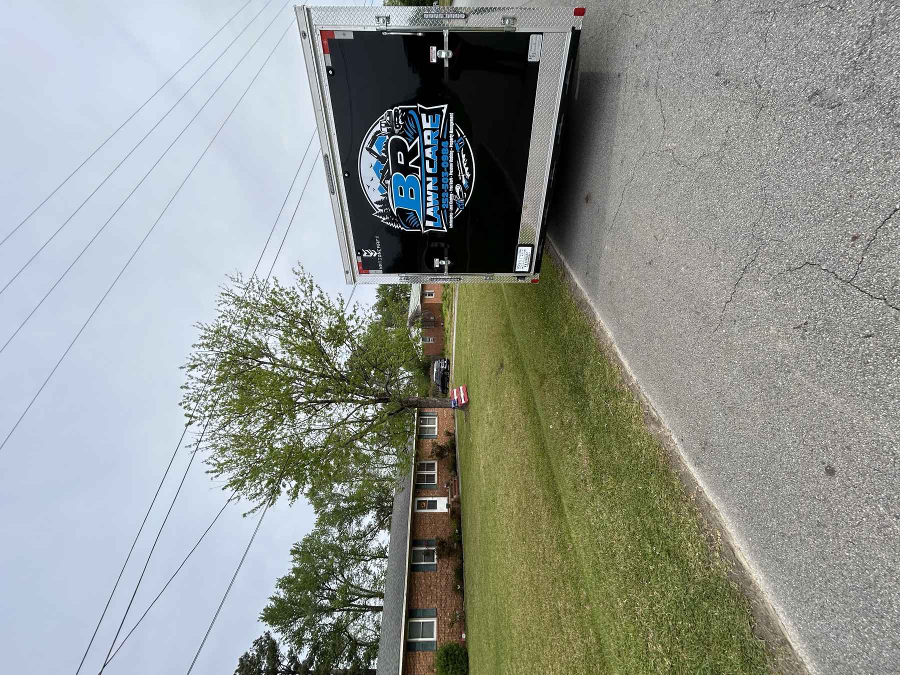 BR Lawn Care branded trailer on a residential job