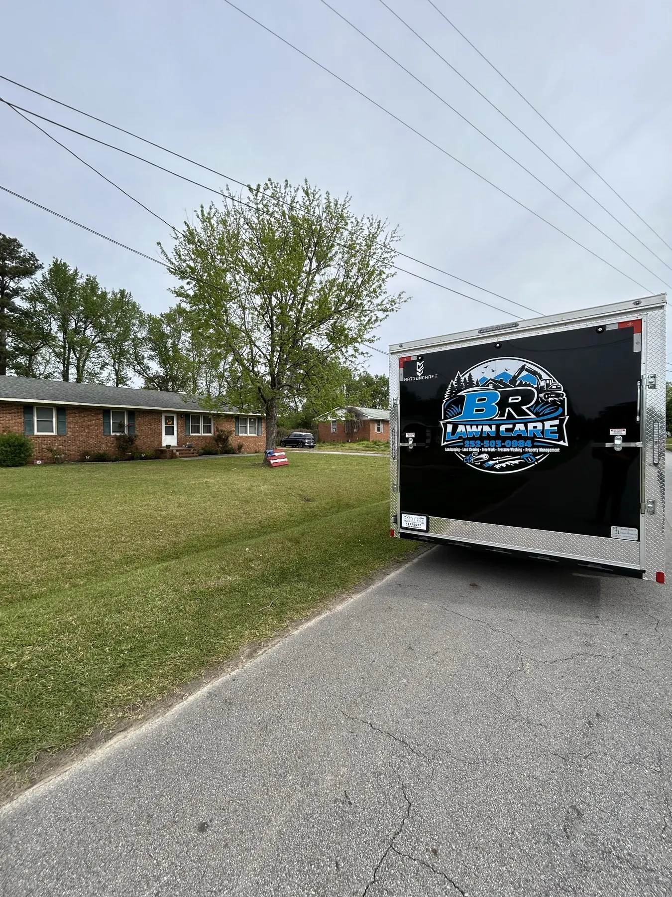 BR Lawn Care branded trailer on a residential job